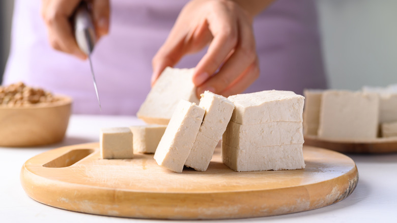 Person cutting tofu