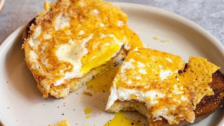 cacio e pepe fried eggs served on piece of toast