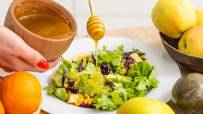 drizzling honey over salad