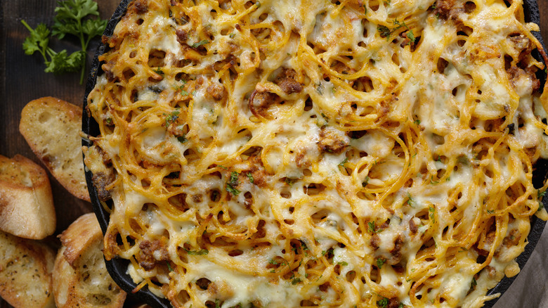 close-up of baked spaghetti with melted cheese and sauce