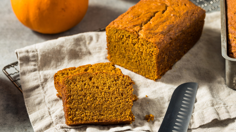 Sliced pumpkin loaf on cooling rack.