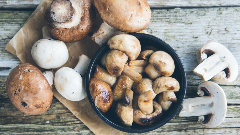 Raw and cooked mushrooms on a table