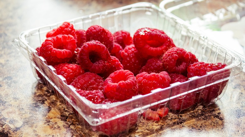 clamshell container of raspberries