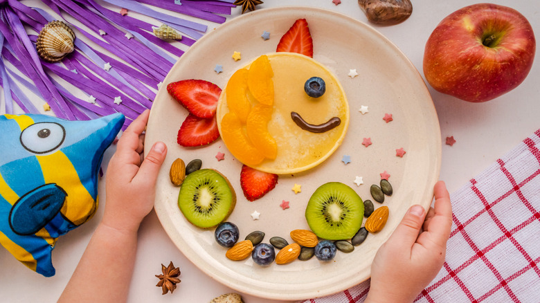 Pancake and fruit assembled to look like a fish