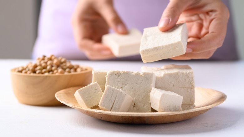 cubes of tofu on wooden plate