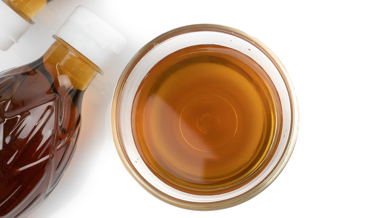 fish sauce in small glass bowl with bottle white background