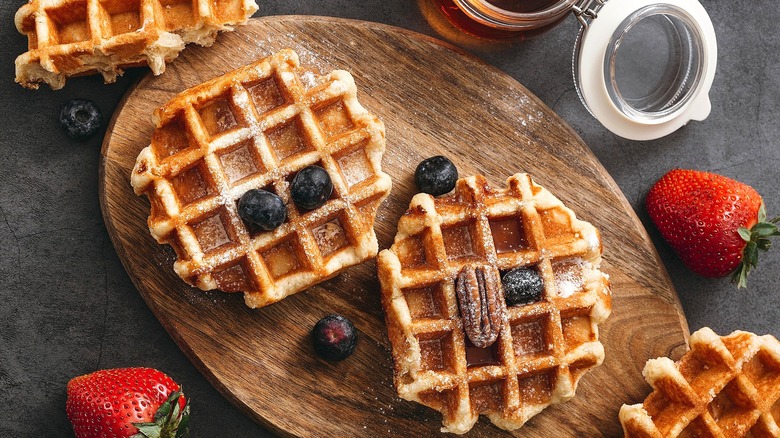 Waffles with fruit on wooden board