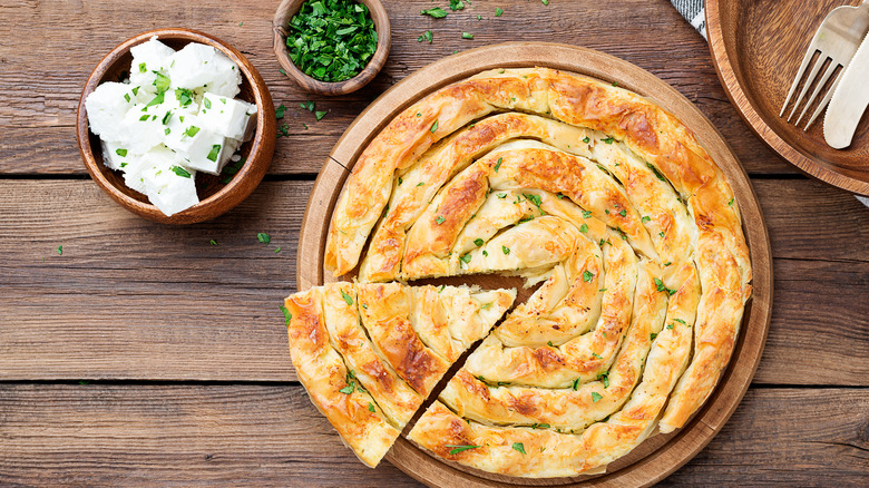 Feta phyllo pie with parsley on table