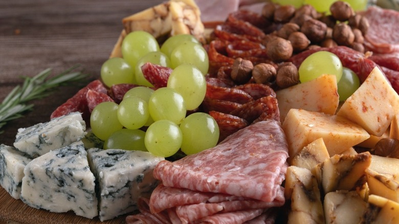 charcuterie board meats, cheeses, grapes