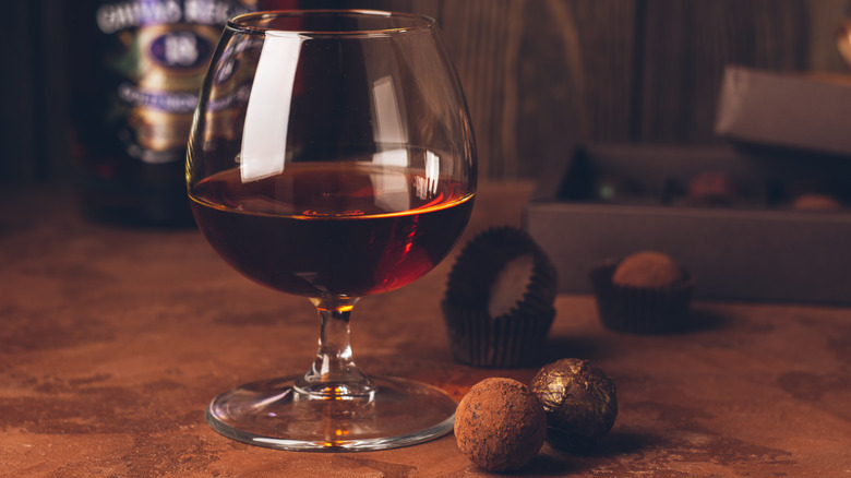 Snifter of cognac with chocolate truffles