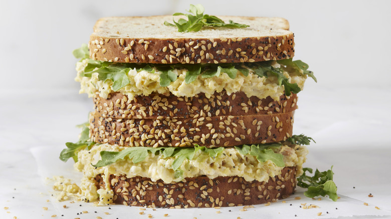 Two egg salad sandwiches stacked