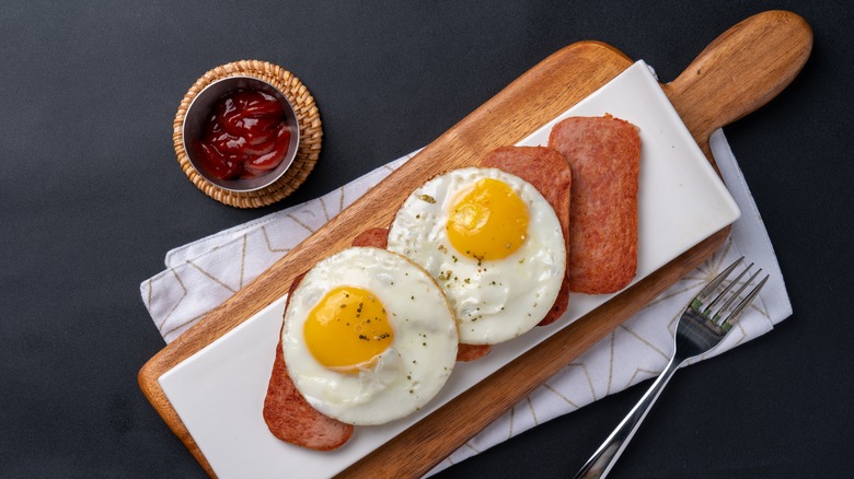 fried spam on a plate with eggs