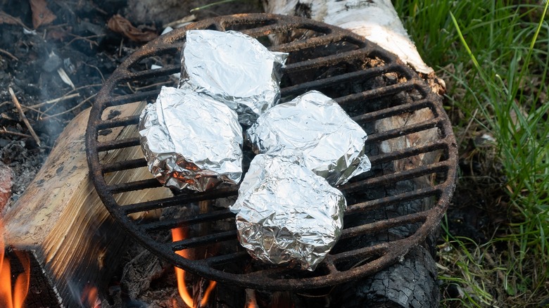 foil-wrapped food on grill