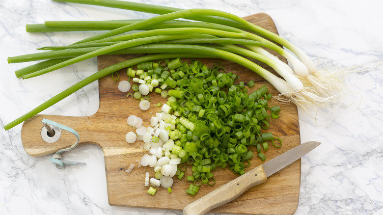 Sliced scallions on cutting board