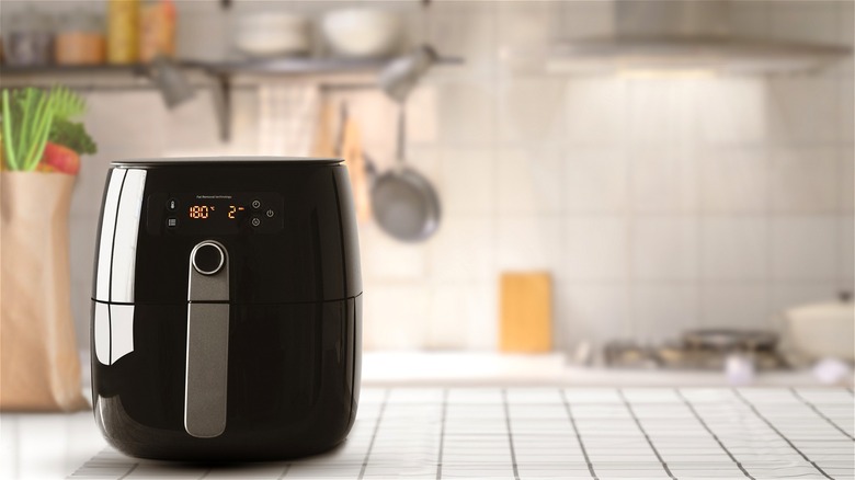 Black air fryer on kitchen counter 