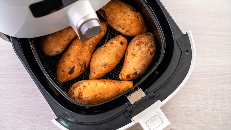 Sweet potatoes in air fryer basket 