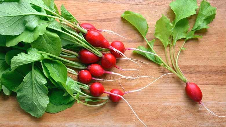 Whole red radishes on wood 