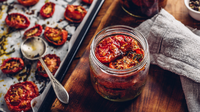 Sun dried tomatoes on sheet pan and in jar