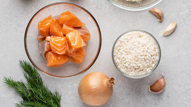 Raw salmon cubes with rice and ingredients