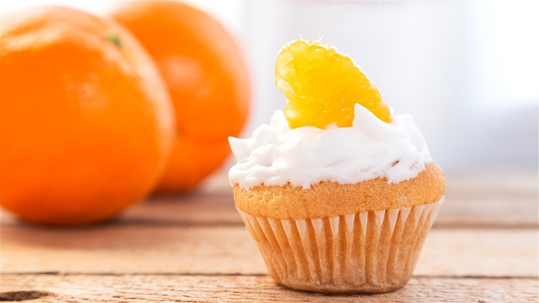 Cupcake with whipped cream and orange 