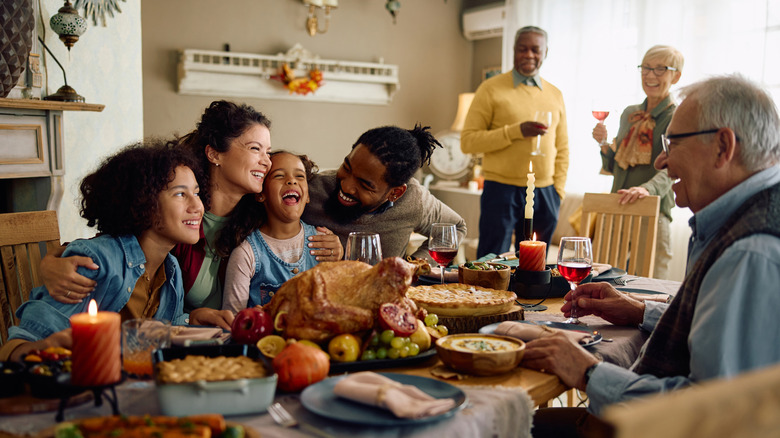 Family celebrating Thanksgiving dinner at table