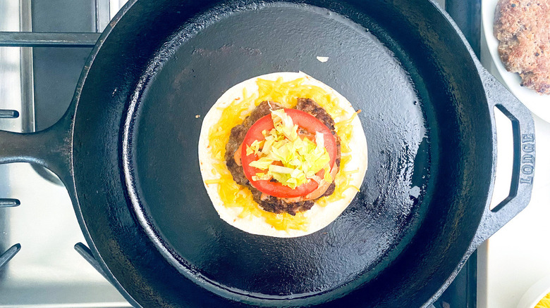 burger on tortilla in pan