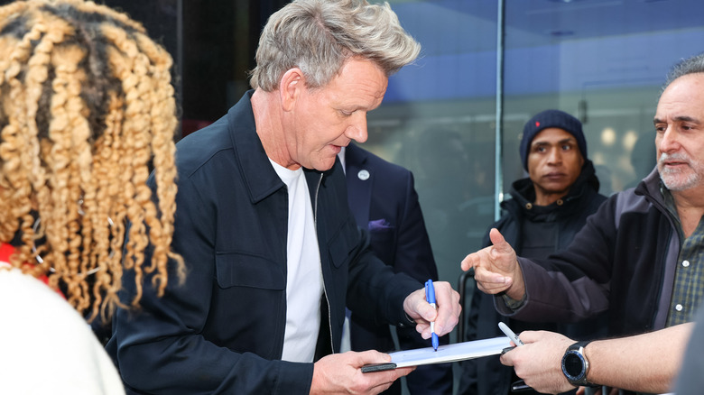 Gordon Ramsay signing autographs