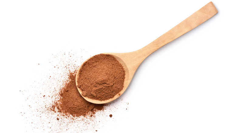 Wooden spoon of chocolate malt powder