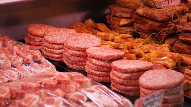 Raw burger patties in shop