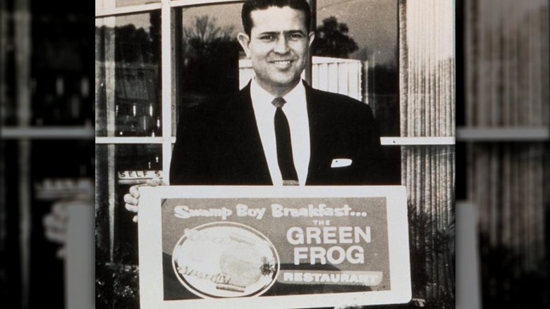 Bill Darden holding a Green Frog sign