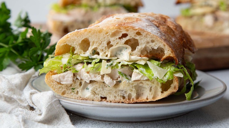 Chicken sandwich with lettuce on a white plate