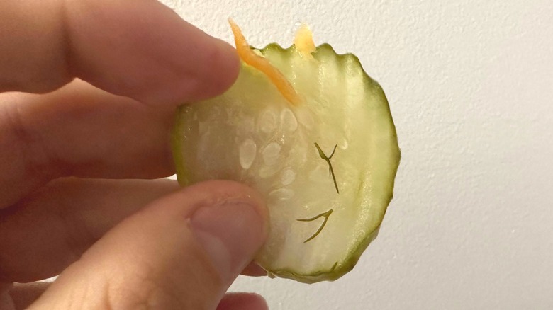 close up of held pickle chip