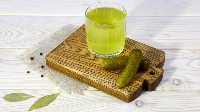 pickle juice in glass with pickles