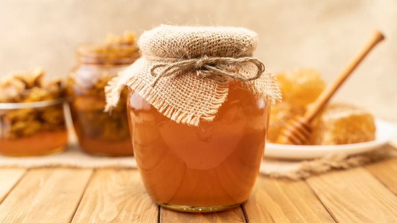 Honey jar near honeycomb