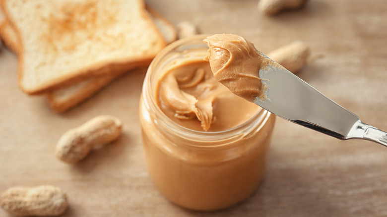 Peanut butter jar with knife