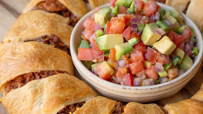 meat-filled bread ring surrounding a bowl of salsa