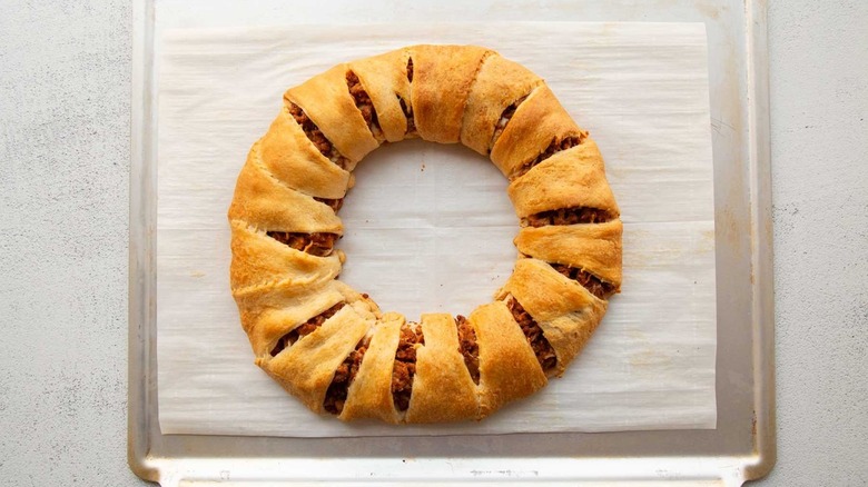 meat-filled bread ring on baking sheet