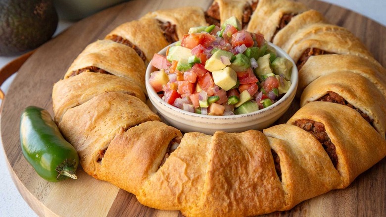 meat-filled bread ring surrounding a bowl of salsa