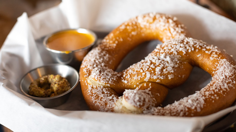 soft pretzel with cheese sauce and mustard