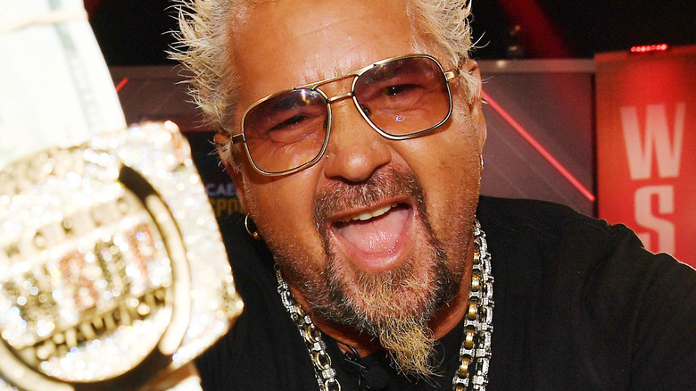 Guy Fieri holding up money and screaming