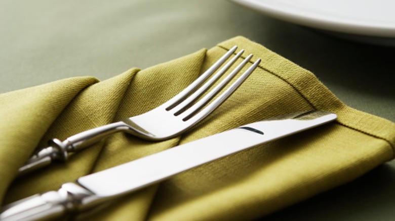 Knife, fork, and linen napkin