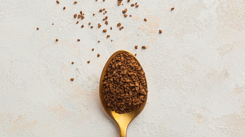 Instant coffee granules on spoon