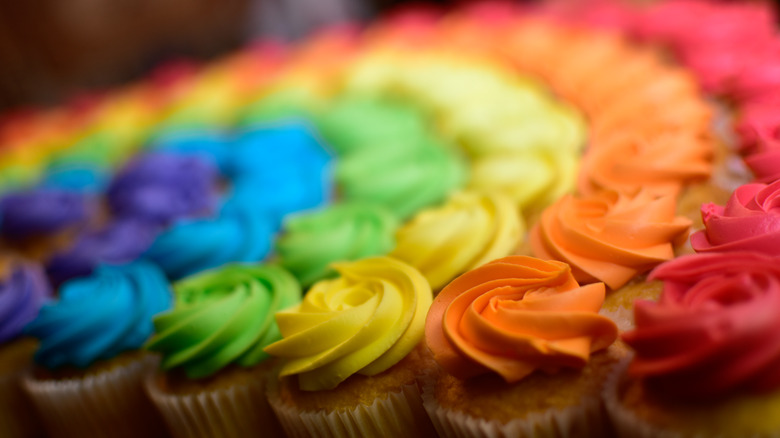 Rainbow-themed cupcakes on display