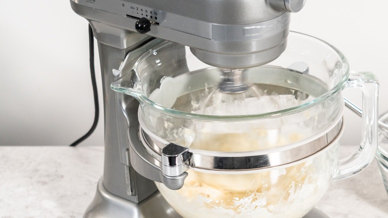 Mixer beating white frosting