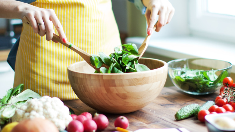 tongs tossing salad