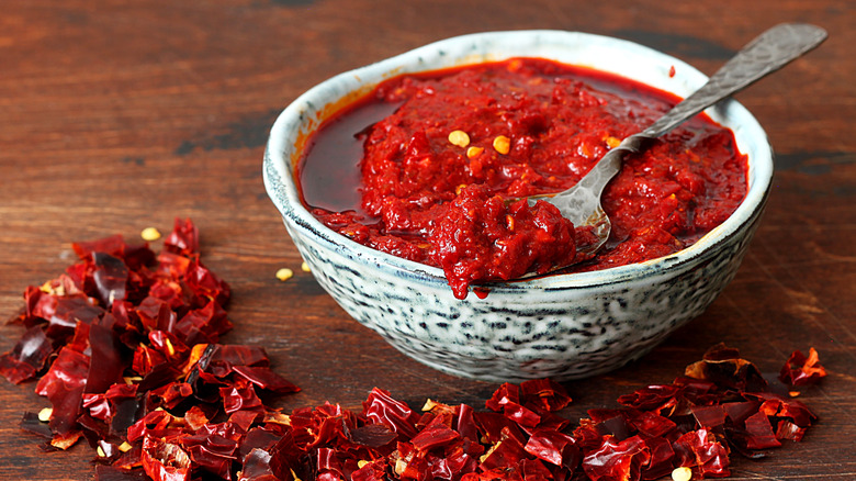 Homemade harissa with chiles around bowl