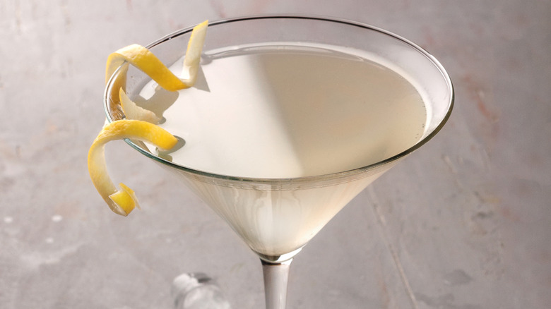 dirty martini with lemon garnish on bar