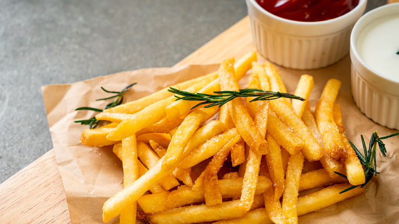 French fries on board with ketchup