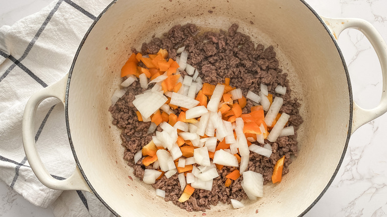 ground beef onions and bell pepper in pot