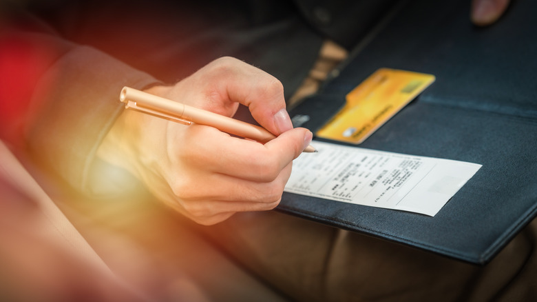 restaurant diner signing paid receipt